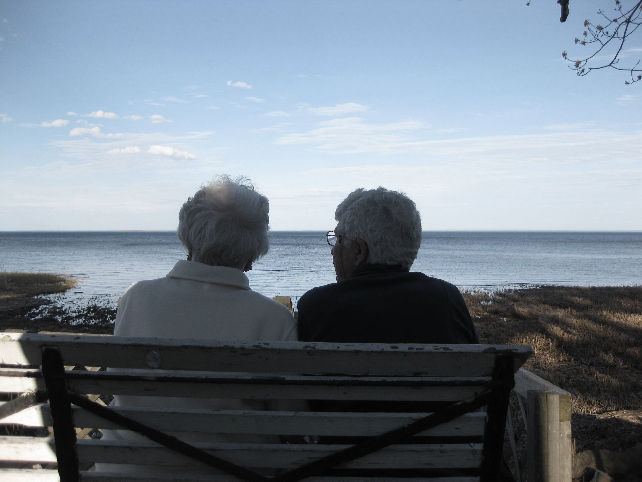 Sisters sitting by the ocean.